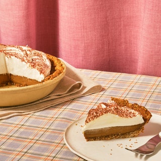 A towering Salted Coffee Custard Pie with a slice cut out