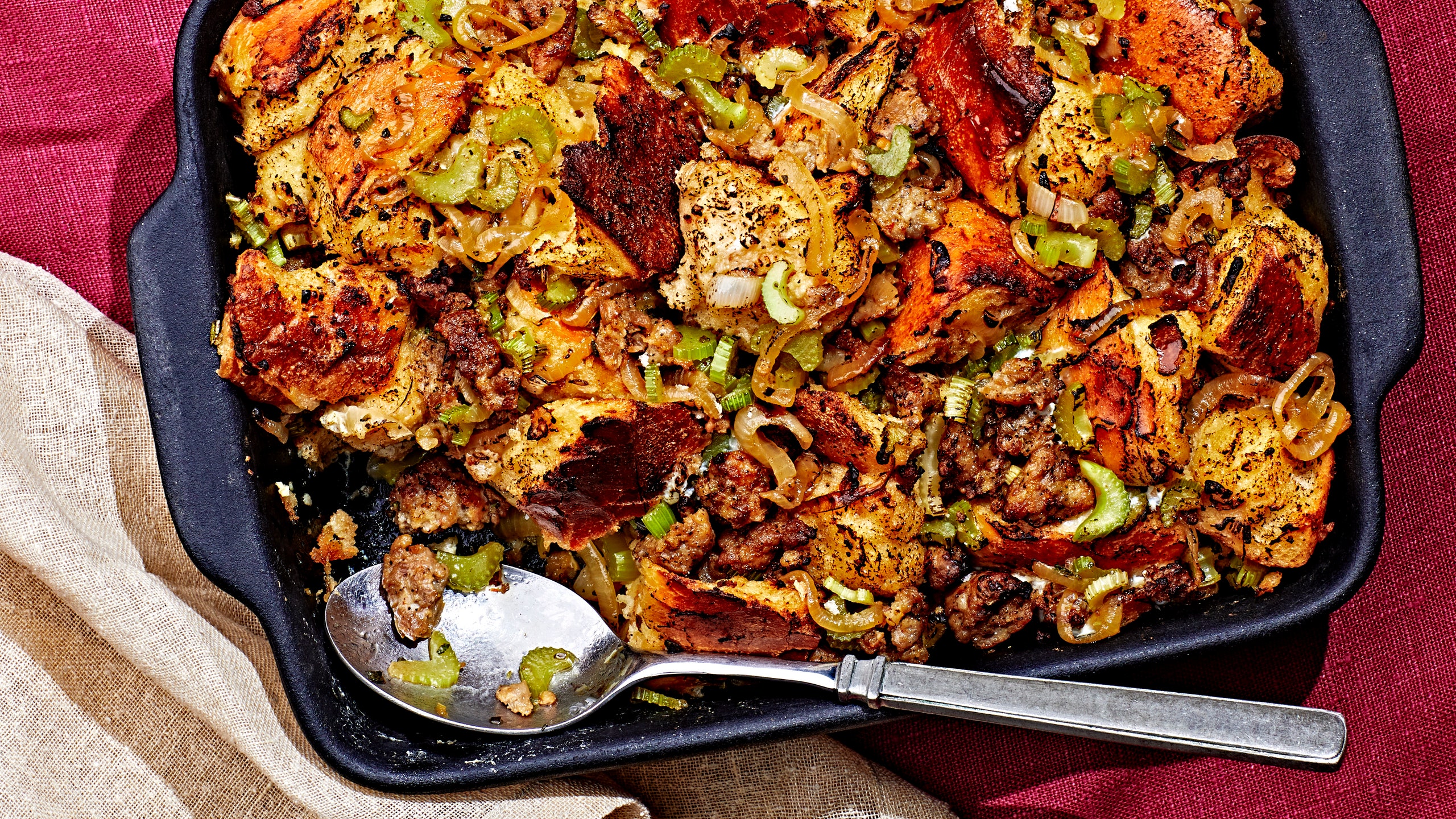 Makeahead stuffing in a casserole dish with a corner scoop removed.