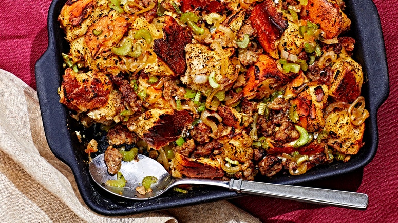 Makeahead stuffing in a casserole dish with a corner scoop removed.