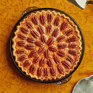 Sweet Potato Pecan Pie on a golden brown patterned fabric background